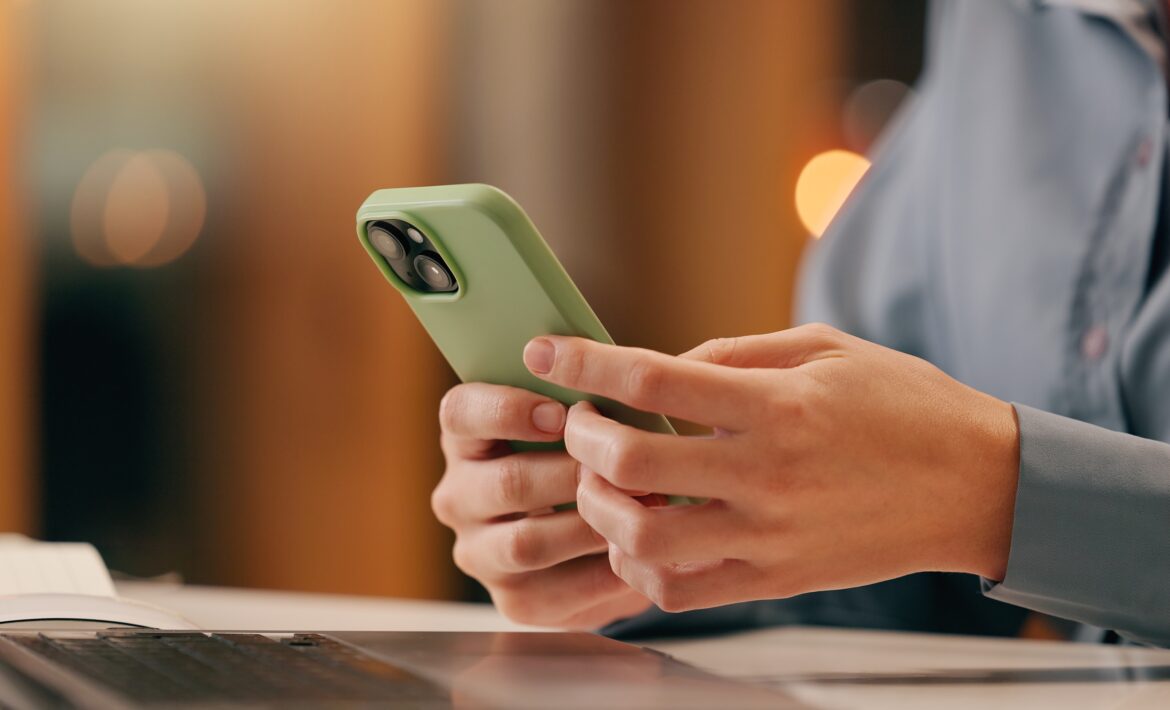 person on a computer and phone