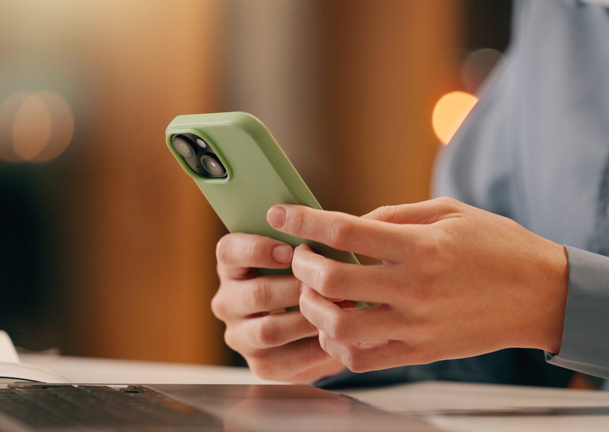 person on a computer and phone